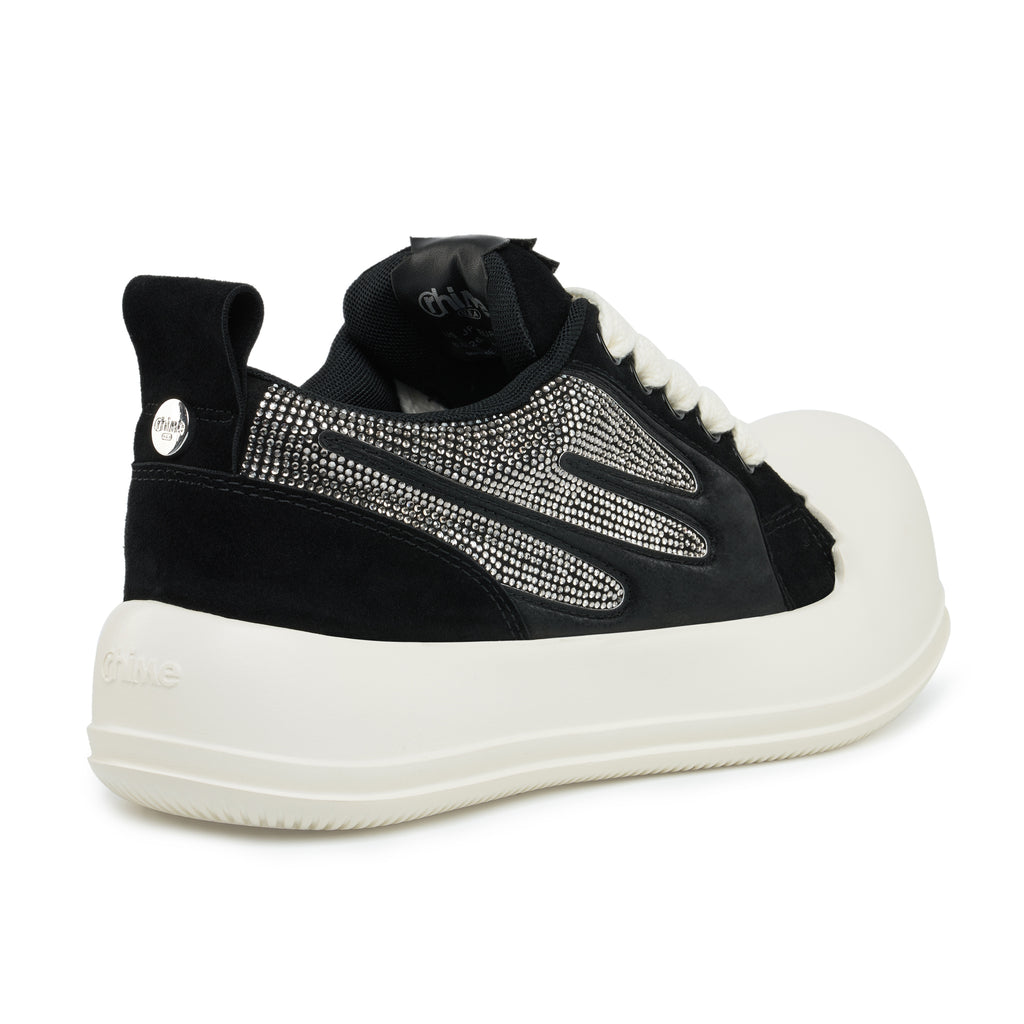 AstroPod Black Rhinestone Onyx sneaker with black uppers, silver-tone rhinestones and off-white soles, viewed at an angle from the heel and side.