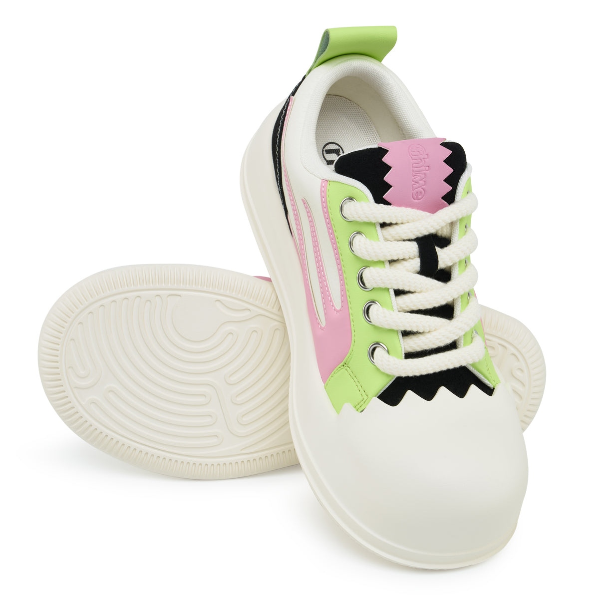 AstroPod Cosmic Bubble sneakers with lime green and pink panels, black accents and white soles, arranged to show the laces and grooved underside.
