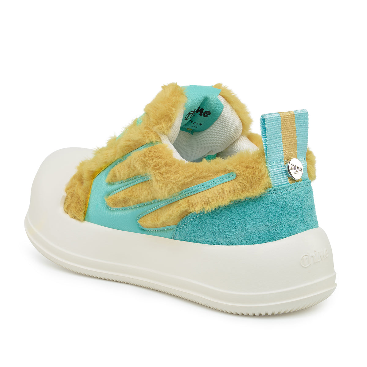 AstroPod DeJ Loaf Yellow World sneaker with fluffy yellow uppers, turquoise accents and white soles, viewed at an angle from the heel and side.