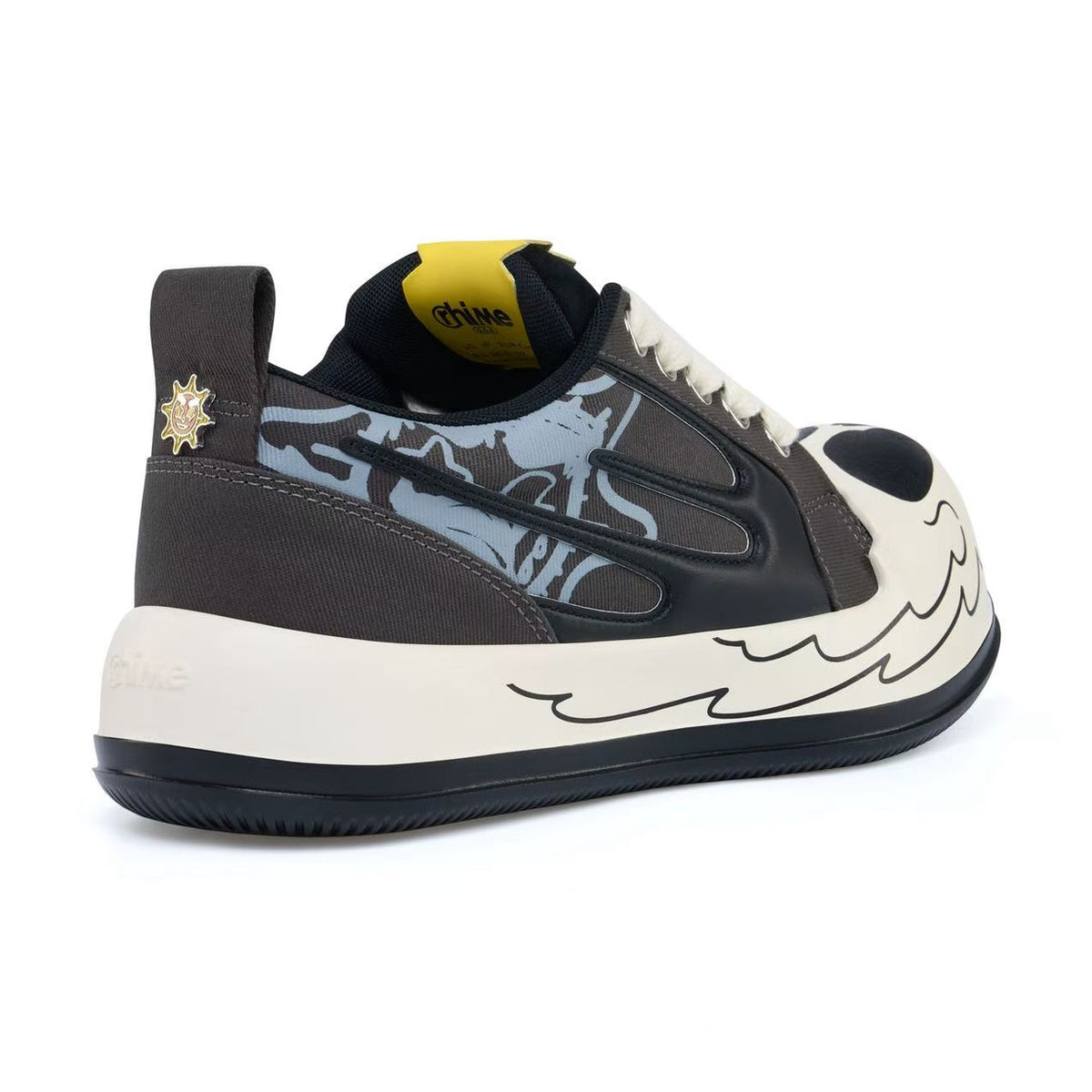 AstroPod Glo Gang sneaker with gray-and-black graphics, white laces and printed light-colored sidewalls, viewed at an angle from the heel and side.
