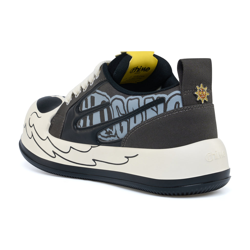 AstroPod Glo Gang sneaker with gray-and-black graphics, white laces and printed light-colored sidewalls, viewed at an angle from the heel and side.